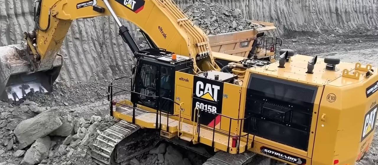 Excavator loading rock at mine site — construction machinery parts source factory